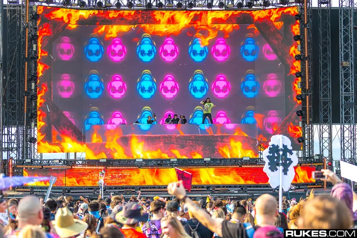 The Paradox stage in daylight, a wide LED wall showing pink and blue artwork above the deck, the crowd in front of it.